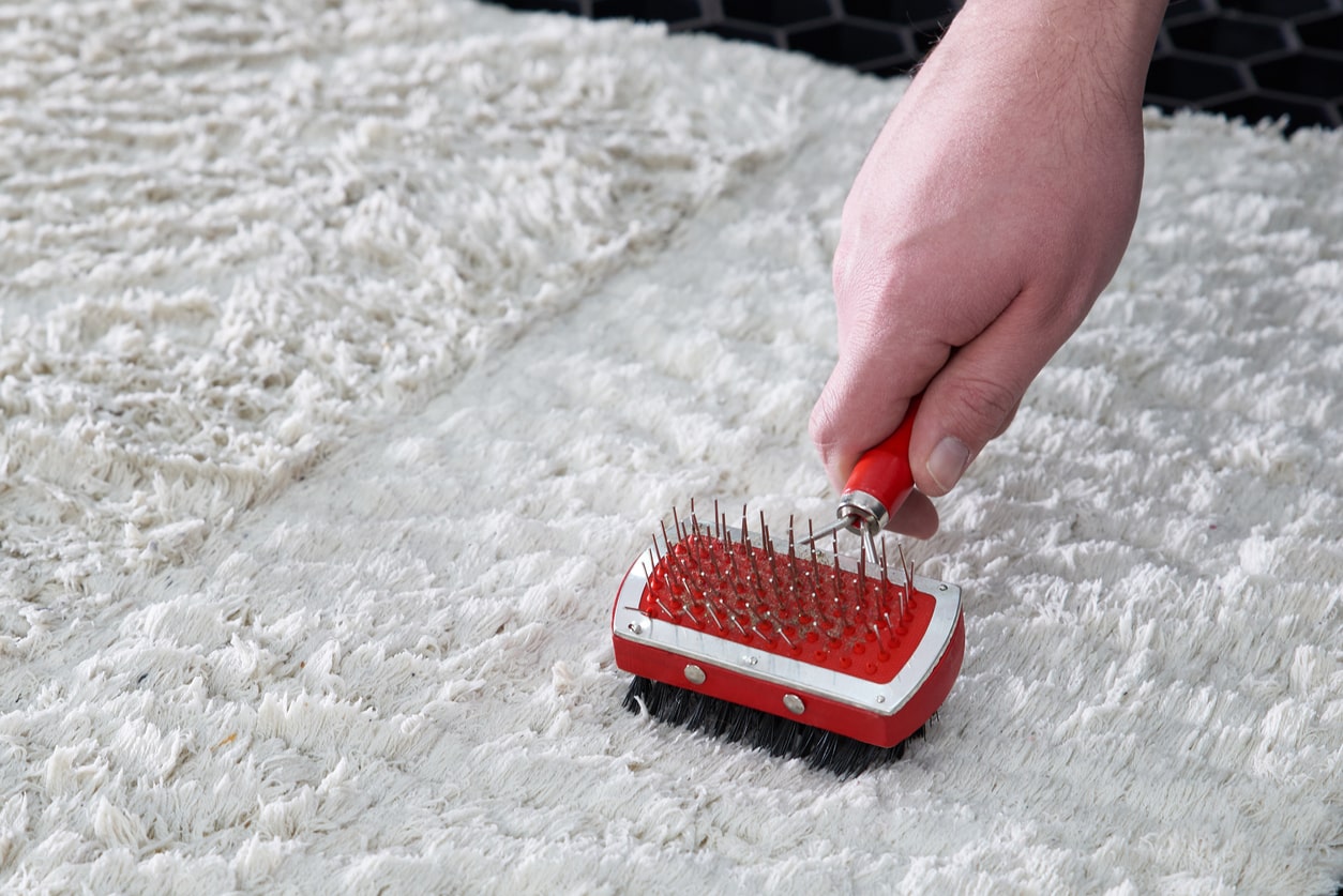 gently grooming wool rug with brush