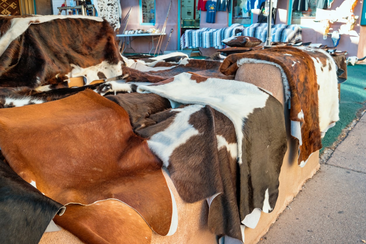 various cowhide rugs ready to be cleaned